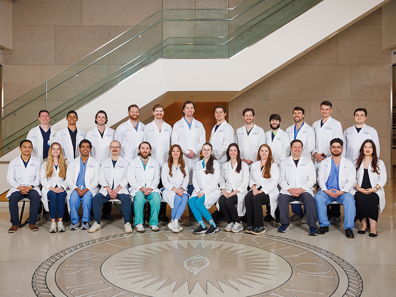 Group photo of radiology residents inside the School of Medicine.